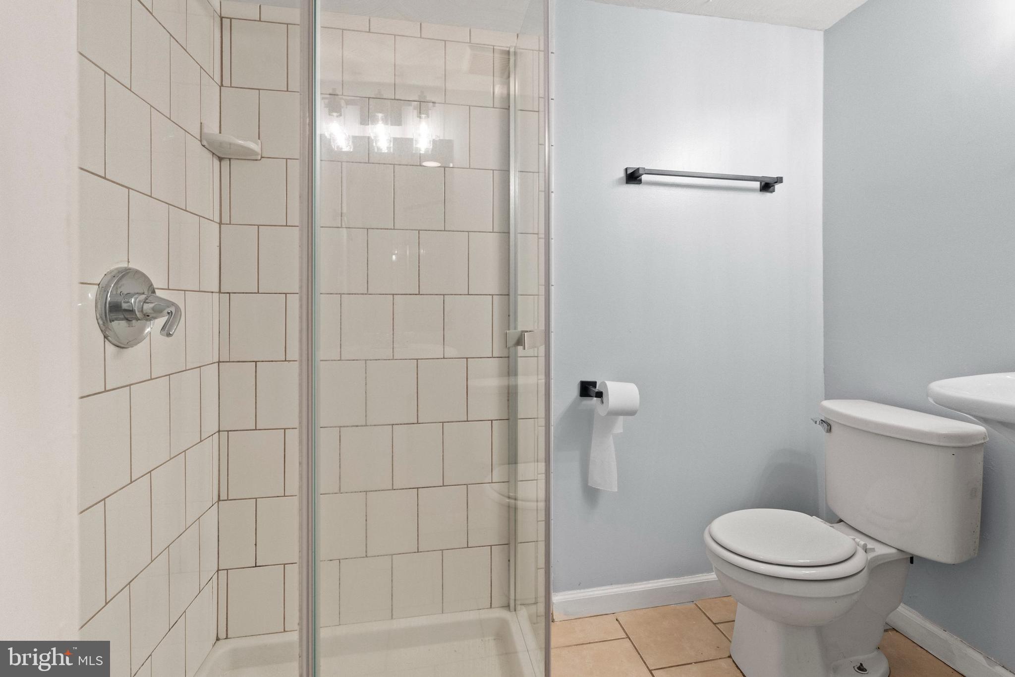 574 Brisbane Road Baltimore, MD 21229 - Photo 30 of 38 a bathroom with a toilet and shower