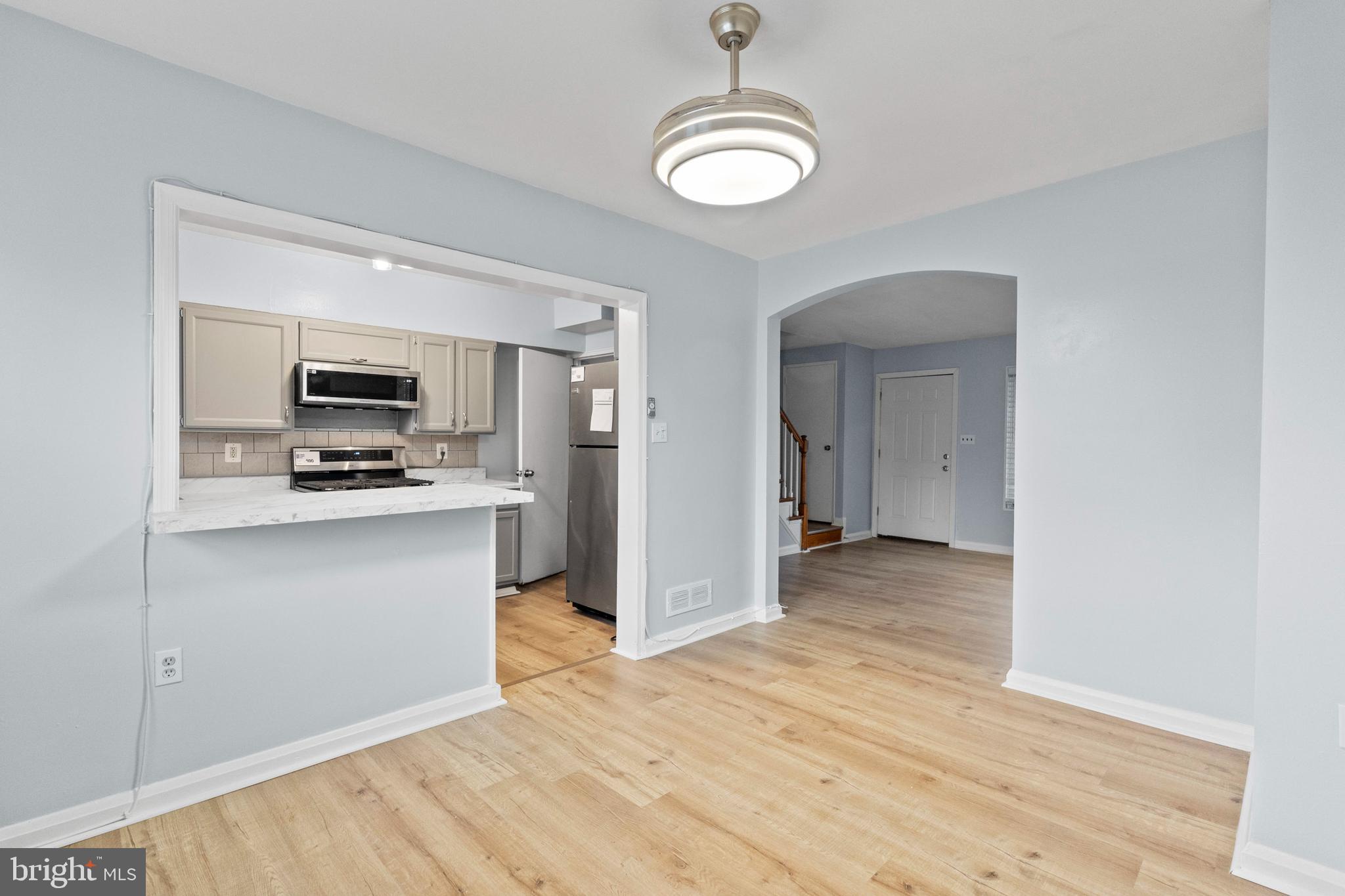 574 Brisbane Road Baltimore, MD 21229 - Photo 8 of 38 a view of a kitchen with wooden floor and a sink