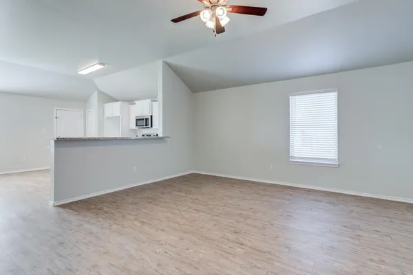 an empty room with a empty space and windows