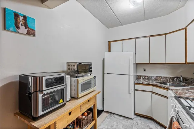 a kitchen with cabinets and steel appliances