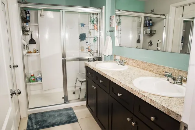 a bathroom with a granite countertop sink mirror and bathtub