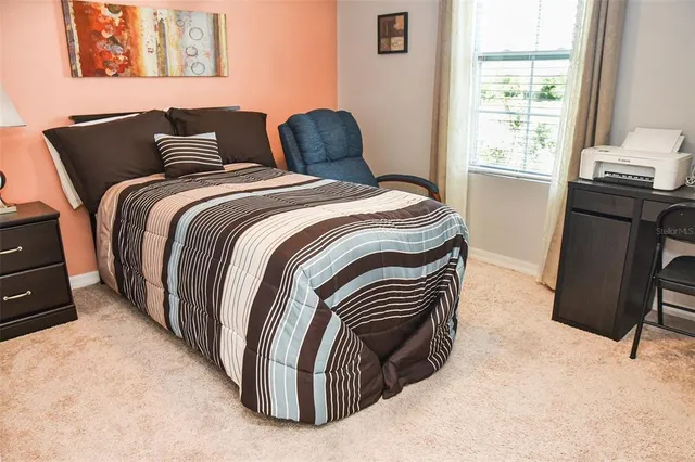 a bedroom with furniture and a window