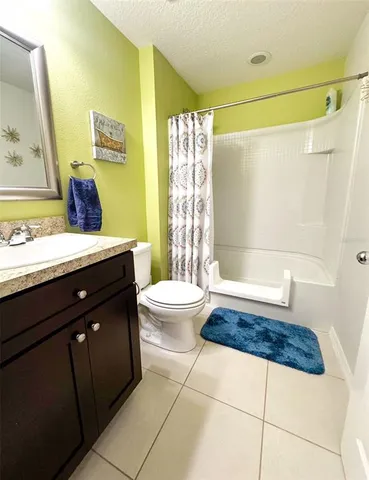 a view of a house with a yard and trees