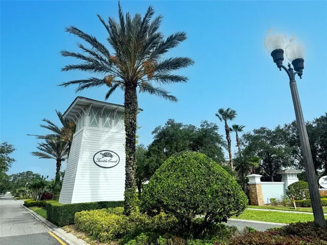an aerial view of a house with a yard and lake view
