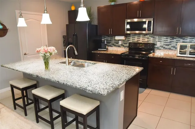a kitchen with a counter space a sink and appliances