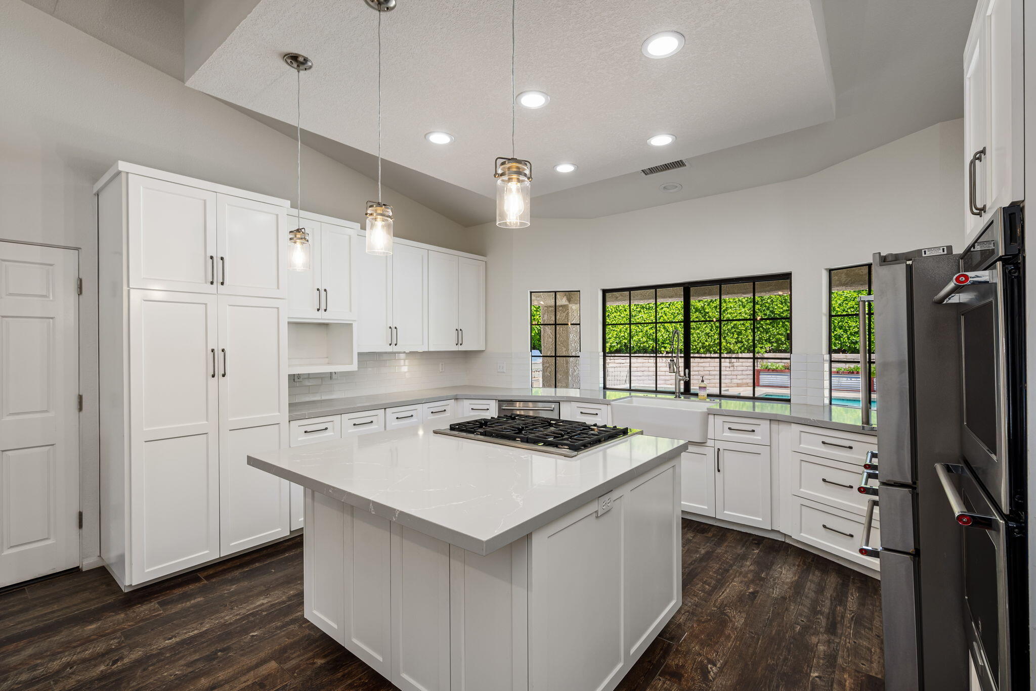 79540 Bermuda Dunes Drive Bermuda Dunes, CA 92203 - Photo 15 of 27 a kitchen that has a stove a sink a refrigerator and white cabinets with wooden floor