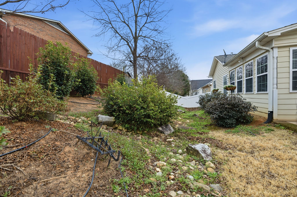 109 Abigail Lane Anderson, SC 29621 - Photo 26 of 29 This private yard features mature landscaping and convenient rain gutters, enhancing outdoor living.