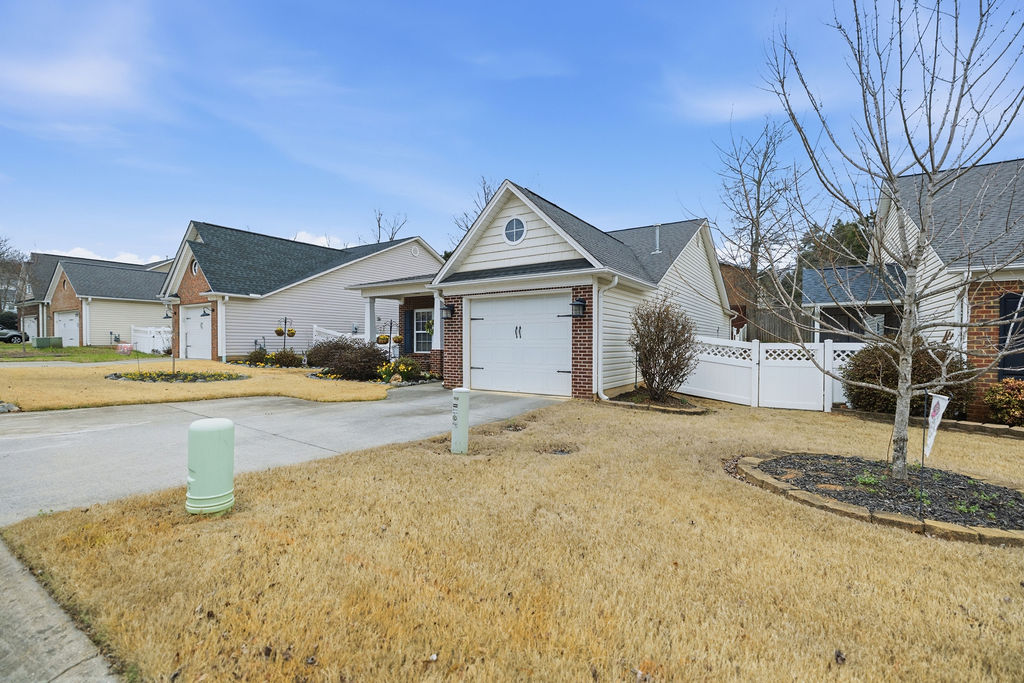This charming home offers a single garage and a fenced yard, perfect for comfortable living.
