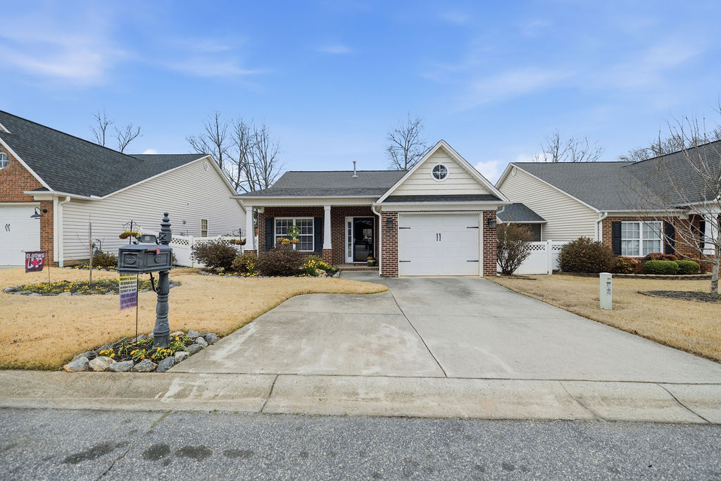 This charming home offers curb appeal with classic brick accents and a welcoming porch.
