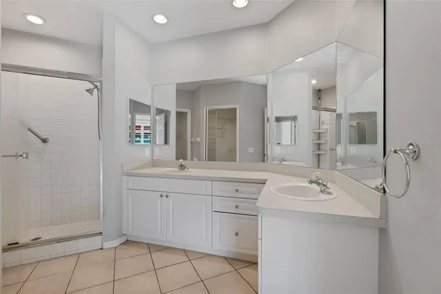 a bathroom with a shower sink and mirror