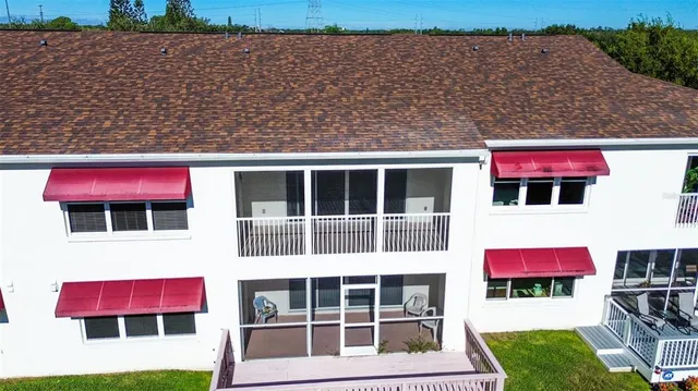 an aerial view of a house with a garden and swimming pool