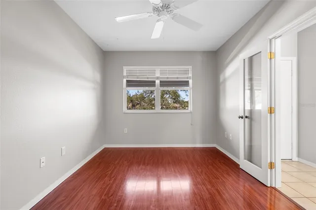 a view of an empty room with wooden floor