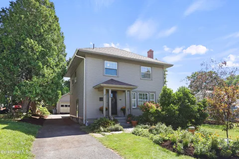 a front view of a house with garden