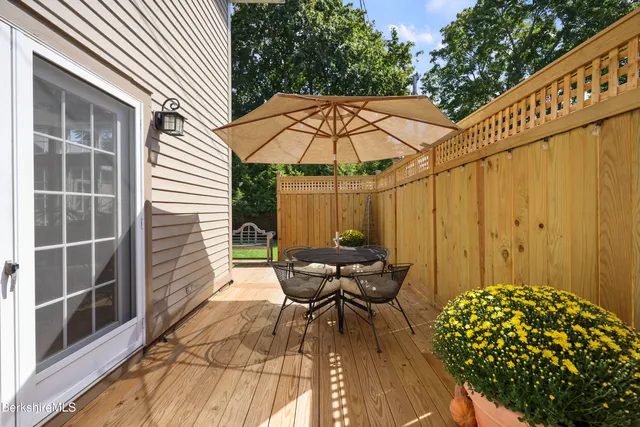 a backyard of a house with table and chairs