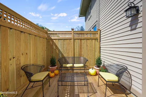 a view of a chairs and table in the balcony