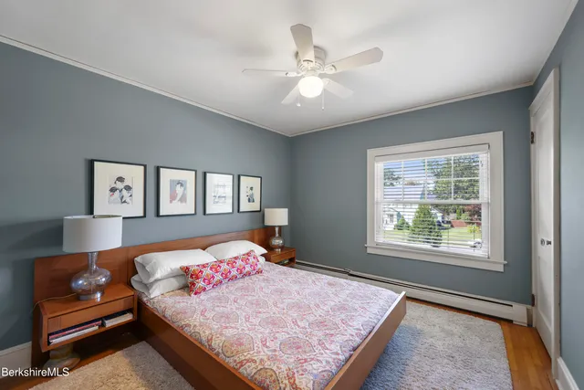 a bedroom with a large bed and a window