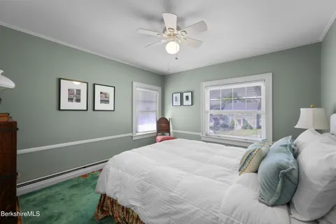 a bedroom with a large bed and a window