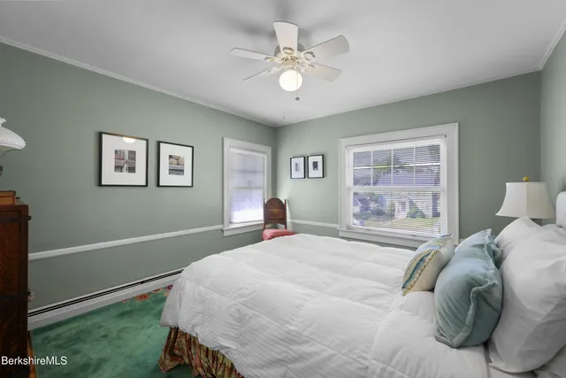 a bedroom with a large bed and a window