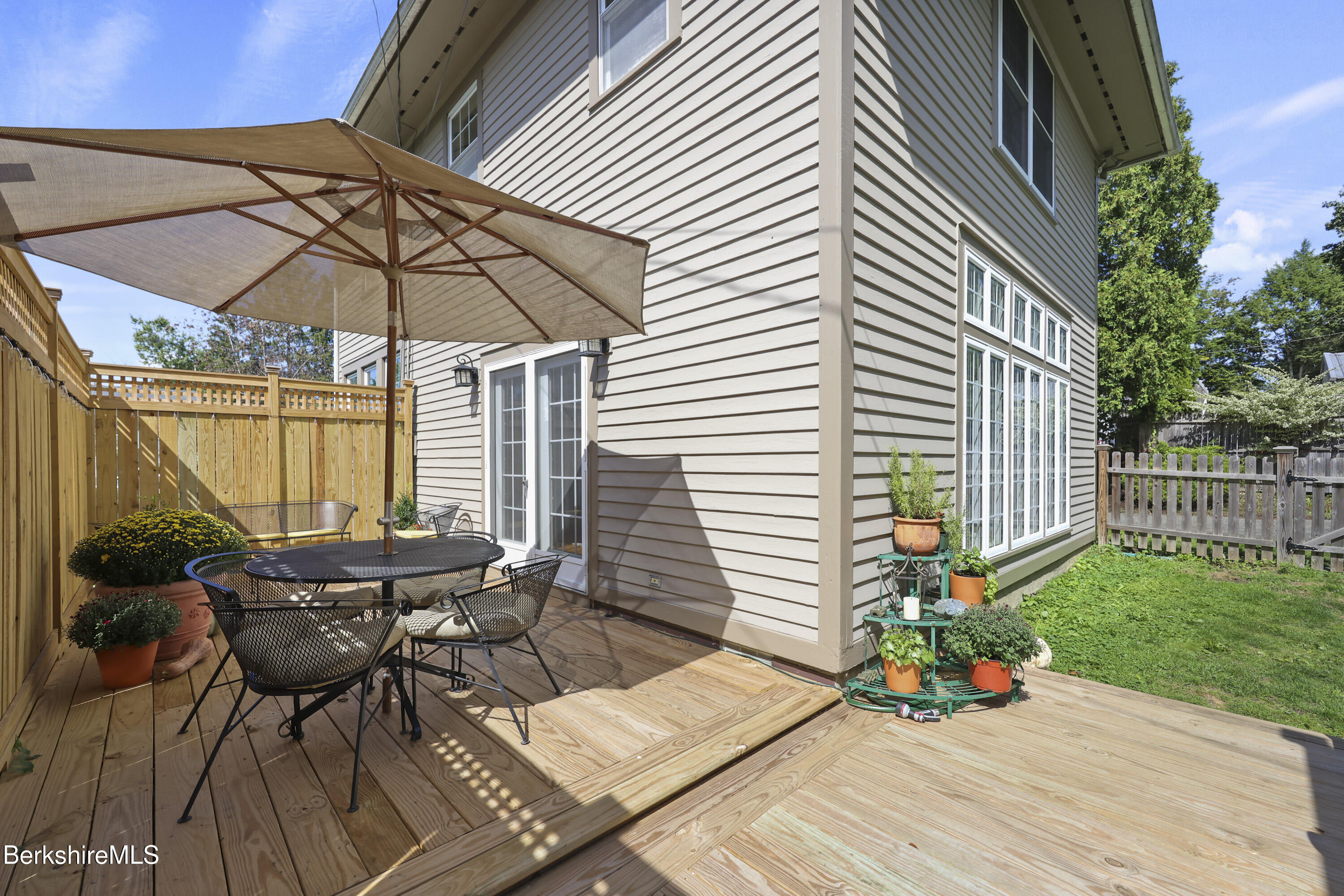 39 Lexington Parkway Pittsfield, MA 01201 - Photo 36 of 48 a view of a patio with a table and chairs under an umbrella