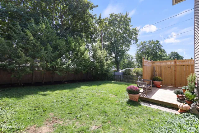 a view of a backyard with sitting area