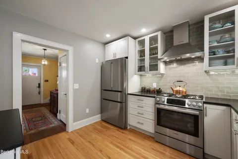 a kitchen with stainless steel appliances granite countertop a stove and a refrigerator