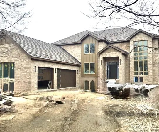 a front view of a house with a yard and glass windows