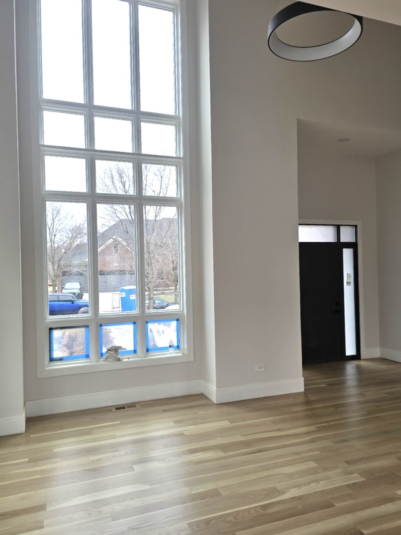 7234 Roxbury Court Long Grove, IL 60060 - Photo 14 of 17 a view of an empty room with wooden floor and a window