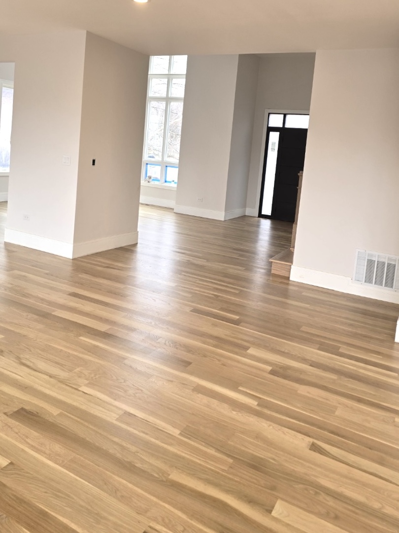 7234 Roxbury Court Long Grove, IL 60060 - Photo 22 of 34 an empty room with wooden floor and windows