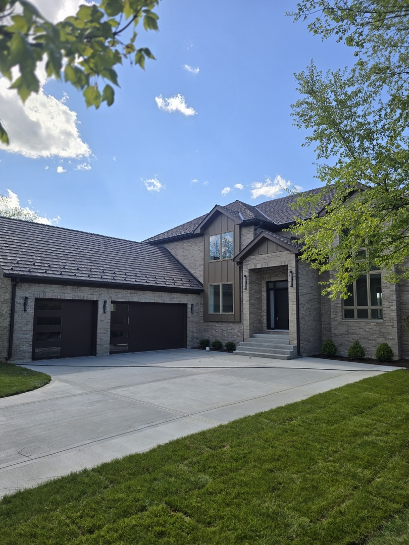 7234 Roxbury Court Long Grove, IL 60060 - Photo 4 of 34 a front view of a house with a garden and trees