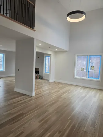 a view of a room with wooden floor and window