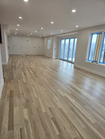 a view of an empty room with windows