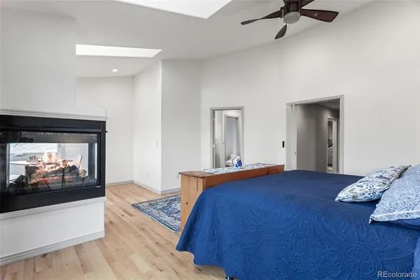 a bedroom with a bed and a television on table