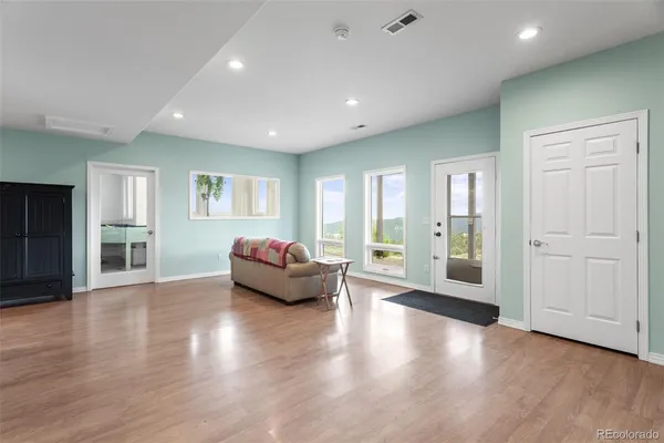 a living room with furniture and wooden floor