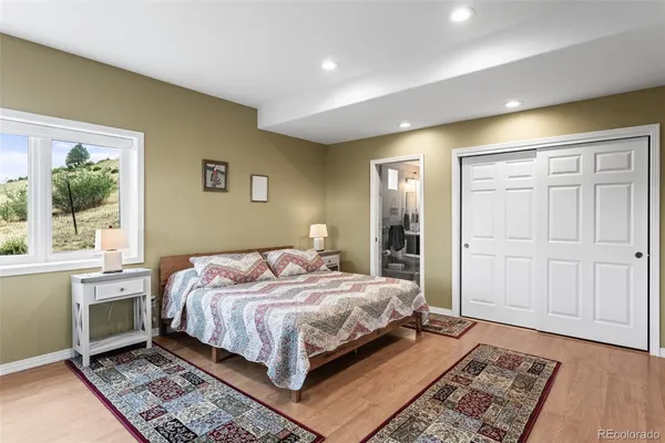 a bedroom with a large bed and a window