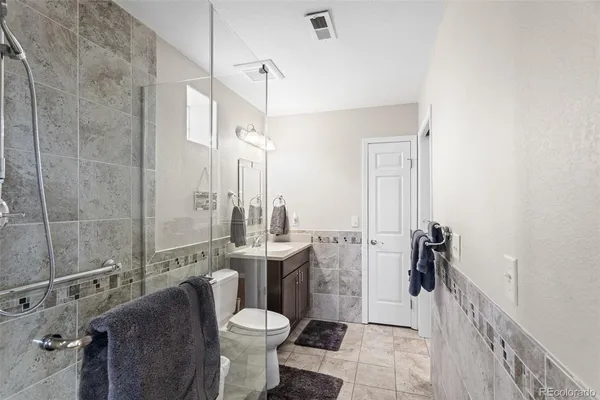 a bathroom with a toilet sink and shower