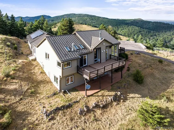 an aerial view of a house with a yard and lake view