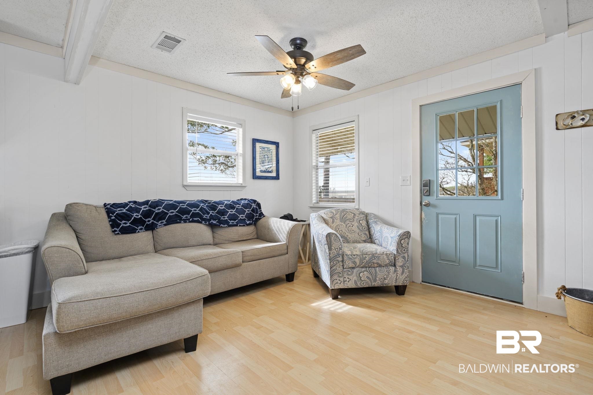 7947 Bayshore Drive Elberta, AL 36530 - Photo 13 of 26 Living room with wood finished floors, a ceiling fan, a textured ceiling, and wood walls