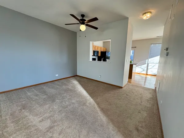 an empty room with a large mirror and fan