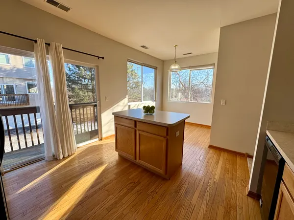 a room with wooden floor and large window