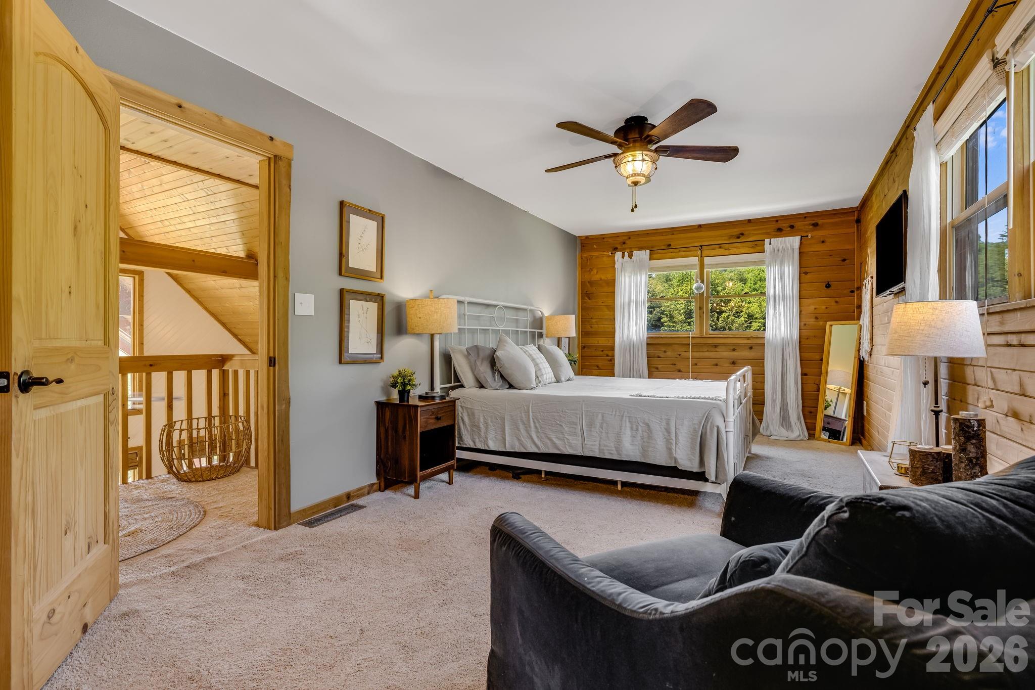 694 Boulder Road Marshall, NC 28753 - Photo 24 of 44 a bedroom with a bed and a large window