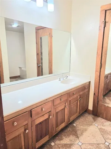 a spacious bathroom with a double vanity sink and a mirror