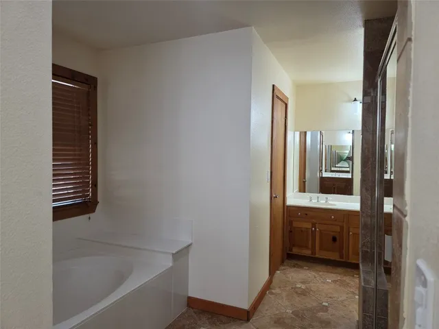 a bathroom with a bathtub and a sink
