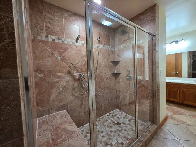 a bathroom with a shower and a sink