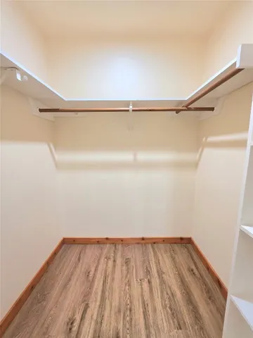 a view of a room with wooden floor