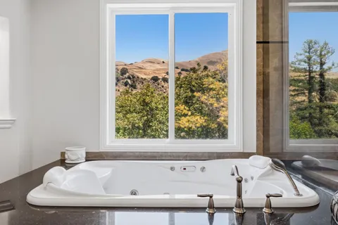 a bath tub sitting next to a window