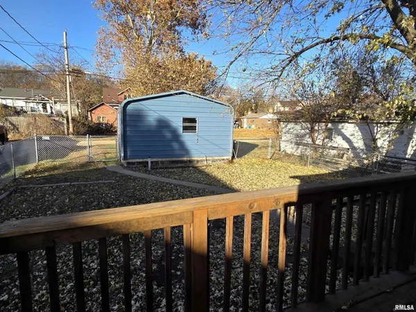a view of a wooden fence next to a yard