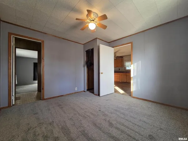 a view of an empty room with a ceiling fan