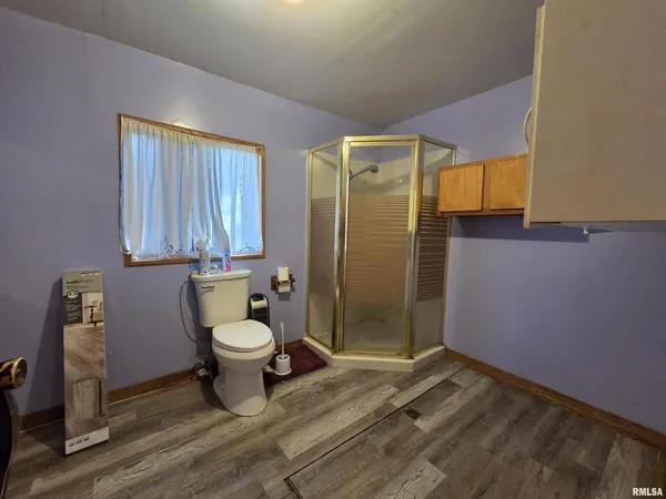 a bathroom with a granite countertop toilet and a shower