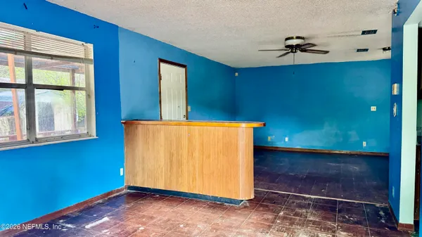 a view of a livingroom with a ceiling fan and window