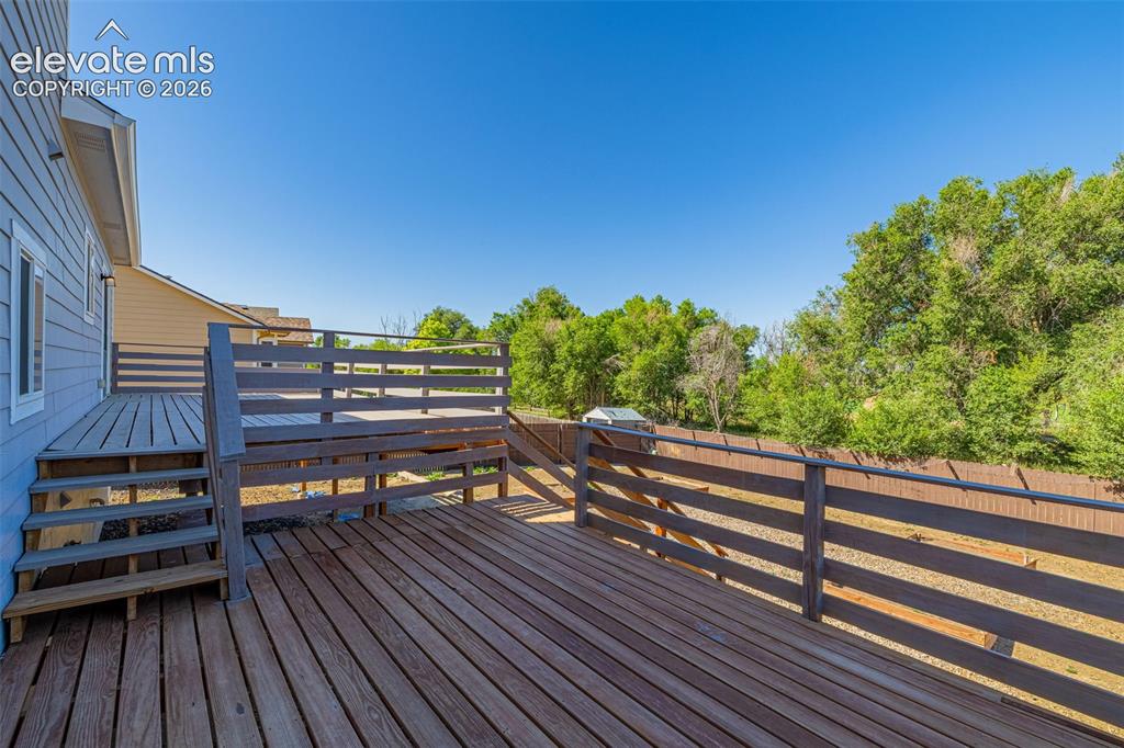 11185 Falling Star Road Fountain, CO 80817 - Photo 29 of 46 a view of a roof deck with wooden floor and fence